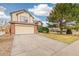 Charming two-story home featuring a two-car garage, brick accents, and a well-maintained front yard with mature tree at 10663 Dexter Dr, Thornton, CO 80233