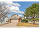 Charming two-story home with a two-car garage, brick accents, and a well-maintained front yard and mature trees at 10663 Dexter Dr, Thornton, CO 80233