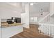 Modern kitchen with white cabinets, granite countertops, stainless steel appliances, and hardwood floors at 10663 Dexter Dr, Thornton, CO 80233
