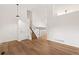 Bright living room with hardwood floors, a vaulted ceiling, and stairs to the upper level at 10663 Dexter Dr, Thornton, CO 80233