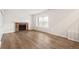 Spacious living room featuring a brick fireplace and hardwood floors at 10663 Dexter Dr, Thornton, CO 80233