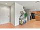 Inviting entryway featuring wood flooring, a console table, a round mirror, and views of the kitchen at 5453 S Quatar Ct, Aurora, CO 80015