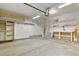 A spacious garage with a workbench, shelves and storage area for tools and equipment at 5453 S Quatar Ct, Aurora, CO 80015