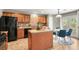 Updated kitchen with tile countertops, wood cabinets, black appliances, and an island at 5453 S Quatar Ct, Aurora, CO 80015