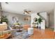 Open-concept living room with hardwood floors and neutral tones, featuring a view of the stairs at 5453 S Quatar Ct, Aurora, CO 80015
