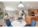Open-concept living room and kitchen with hardwood floors and views of the stairs at 5453 S Quatar Ct, Aurora, CO 80015