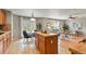 Open concept living space with an island, dining area, and comfortable seating at 5453 S Quatar Ct, Aurora, CO 80015