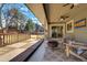 Spacious back patio includes a wood deck, string lights, ceiling fan, fire pit, and lawn at 5666 S Havana Ct, Englewood, CO 80111