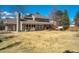 Large, grassy backyard featuring a patio area, hot tub, and plenty of space for outdoor relaxation at 5666 S Havana Ct, Englewood, CO 80111