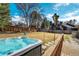 Backyard features a hot tub, lawn, mature trees, and a privacy fence. It is an ideal outdoor space at 5666 S Havana Ct, Englewood, CO 80111