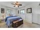 Bright bedroom featuring two windows, a vintage chest, and a comfortable bed with side tables and ample natural light at 5666 S Havana Ct, Englewood, CO 80111