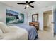 Stylish bedroom featuring a striking surfer art piece, hardwood floors, and a modern dresser with hallway view at 5666 S Havana Ct, Englewood, CO 80111
