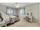 Cozy bedroom featuring neutral walls, plush carpet, and a vanity with a matching stool and large windows at 5666 S Havana Ct, Englewood, CO 80111