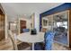 Open concept dining room with backyard views, wooden beams and stylish chair accents at 5666 S Havana Ct, Englewood, CO 80111