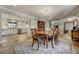 Charming dining room with decorative chandelier and hardwood flooring adjacent to the bright and modern kitchen at 5666 S Havana Ct, Englewood, CO 80111