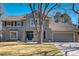 Charming two-story home with neutral gray siding and beautiful landscaping at 5666 S Havana Ct, Englewood, CO 80111