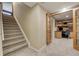 Hallway features carpeted stairs, neutral walls, and leads to office space with built-in shelves at 5666 S Havana Ct, Englewood, CO 80111