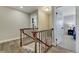 Hallway features hardwood flooring, with stairway, landing, and bedroom access with overhead lighting at 5666 S Havana Ct, Englewood, CO 80111