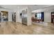 Bright kitchen with stainless steel appliances opens to dining area with chandelier and hardwood flooring at 5666 S Havana Ct, Englewood, CO 80111