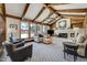 Inviting living room featuring vaulted ceilings with exposed beams and a stone fireplace at 5666 S Havana Ct, Englewood, CO 80111