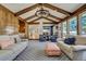 Bright living room with vaulted ceilings, wood paneling, and stylish furniture at 5666 S Havana Ct, Englewood, CO 80111