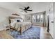 Spacious primary bedroom with hardwood floors, ceiling fan, and large windows for natural light at 5666 S Havana Ct, Englewood, CO 80111