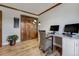 Well-lit office space with ample desk space, neutral walls, and hardwood floors and decorative trim at 5666 S Havana Ct, Englewood, CO 80111