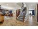 Elegant staircase with decorative carpet runner, dark wood banister and access to living spaces at 5666 S Havana Ct, Englewood, CO 80111
