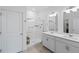 Bright bathroom features a double vanity, walk-in shower, and neutral tile at 13408 Wabash St, Thornton, CO 80602