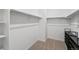 This walk-in closet has ample storage with rods and shelving at 13408 Wabash St, Thornton, CO 80602