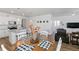 Open-concept dining area adjacent to a modern kitchen featuring white cabinets and stainless appliances at 13408 Wabash St, Thornton, CO 80602