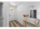 Bright foyer featuring wood floors, a decorative mirror and console table at 13408 Wabash St, Thornton, CO 80602