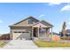 Charming home with stone accents, a welcoming front porch and manicured lawn at 13408 Wabash St, Thornton, CO 80602