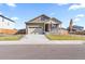 Charming two-story home featuring a covered front porch, well-maintained lawn, and an attached two-car garage at 13408 Wabash St, Thornton, CO 80602