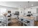 Modern kitchen with granite counters, a stainless steel refrigerator and a breakfast bar with seating at 13408 Wabash St, Thornton, CO 80602