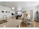 Modern kitchen with granite countertops, stainless steel sink, and open layout to the dining area at 13408 Wabash St, Thornton, CO 80602