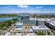 Stunning aerial view of modern high-rise featuring nearby city skyline, lake and lush treetop views at 4200 W 17Th Ave # 625, Denver, CO 80204