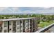 Open balcony displaying city views, green treetops and distant mountain peaks on a sunny day at 4200 W 17Th Ave # 625, Denver, CO 80204