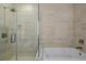 Bright bathroom features a glass shower and a tub at 4200 W 17Th Ave # 625, Denver, CO 80204