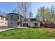 Spacious backyard features lush green grass with an exterior view of the unique modern house at 2025 Ash St, Denver, CO 80207