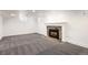 Finished basement featuring a fireplace with stone and tile surround and plush grey carpeting at 2025 Ash St, Denver, CO 80207