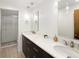 Bathroom features double sinks with marble countertops and a glass-enclosed shower with subway tile at 2025 Ash St, Denver, CO 80207