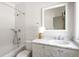 Traditional bathroom with marble countertop vanity, shower-tub combination, and decorative white fixtures at 2025 Ash St, Denver, CO 80207