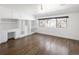 Spacious bedroom boasts hardwood floors, built-in cabinets, and a bright window with dark trim at 2025 Ash St, Denver, CO 80207