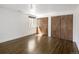 Bedroom features hardwood floors, closet with double doors, and a sunlit window with dark trim at 2025 Ash St, Denver, CO 80207