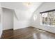 Bright bedroom boasts hardwood floors, recessed lighting, unique round window, and natural light at 2025 Ash St, Denver, CO 80207