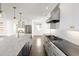 Spacious kitchen with marble island, stainless appliances, and custom white cabinetry at 2025 Ash St, Denver, CO 80207