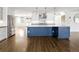 Stylish kitchen island features a marble countertop, custom blue cabinetry, and modern fixtures at 2025 Ash St, Denver, CO 80207