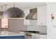 Modern kitchen with white cabinets, stainless steel appliances, and a marble island at 2025 Ash St, Denver, CO 80207