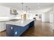Open kitchen design with a large island, stainless steel appliances, and custom cabinetry at 2025 Ash St, Denver, CO 80207